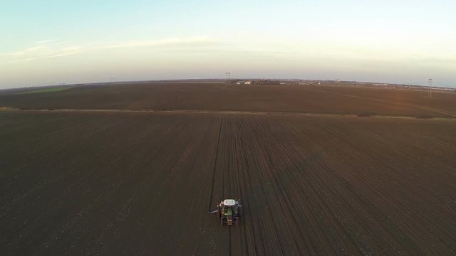 Aerial shot of tractor working in the field.
