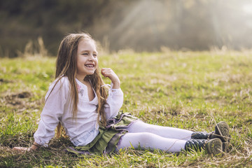 Little, beautiful baby girl laughing and smiling on the backgrou