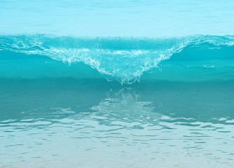 Powerful wave breaks along the shore