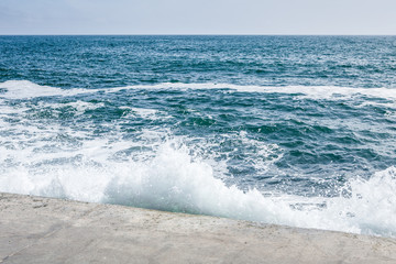 big waves on rocky coast and blue sea