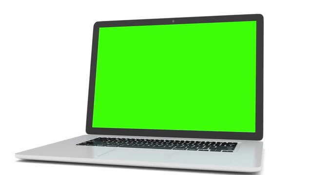 Isolated laptop with green screen on white background. Camera rotating around notebook. Template empty green screen.