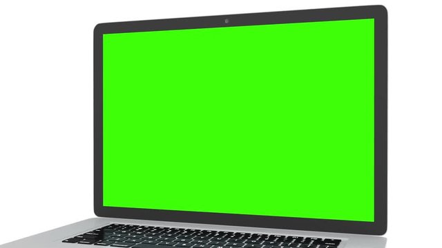 Isolated laptop with green screen on white background. Camera rotating around notebook. Template empty green screen.