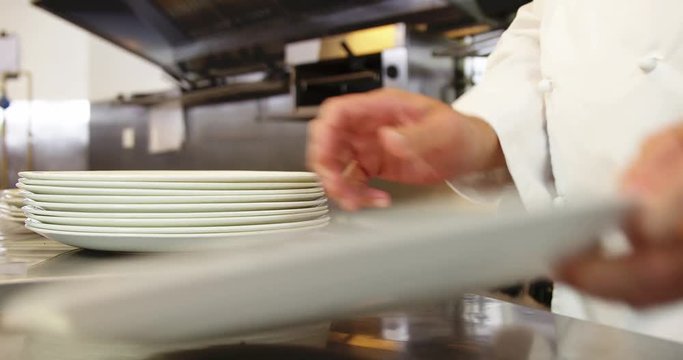 A chef piling up the plates