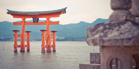 Miyajima Torii is floating on high tide sea.