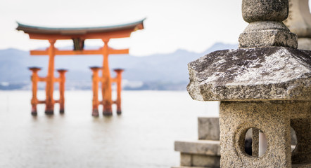 Miyajima Torii is floating on high tide sea.