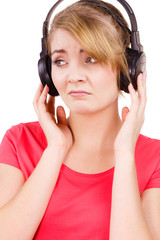Woman sad girl in big headphones listening music