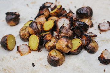 Fried bacon and potatoes lie on a pita. The concept of eating outdoors in the weekend.