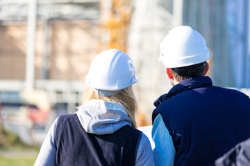 Two workers working outside on a construction site