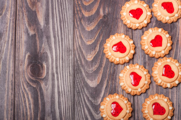 cookies with jelly on a dark wooden background