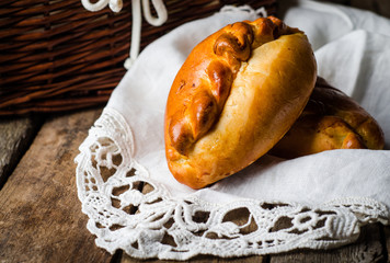 Pies stuffed meat on wooden background, ukrainian or russian cuisine. Selective focus