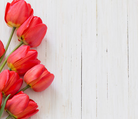 Fototapeta na wymiar beautiful tulips on wooden background