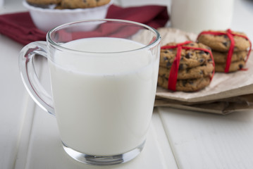 Very sweet retro bottle of milk with cookie on old table