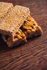 Kozinaki of sesame and peanut on a wooden background