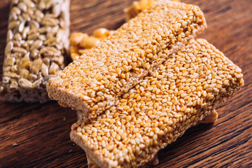 Kozinaki of sesame and peanut on a wooden background