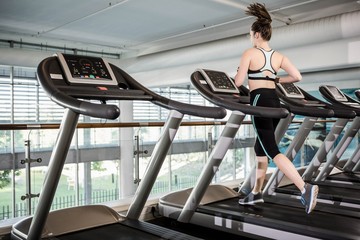 Fit brunette running on treadmill