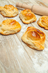 wheat buns, rolls with cinnamon, rolling-pin, meal on the table