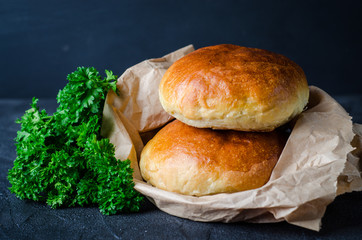 Homemade buns for burgers on dark slate background. Selective focus