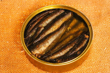 open can with of sprats on sackcloth background
