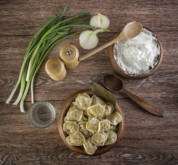 meat dumpling with glass of vodka on the wooden table