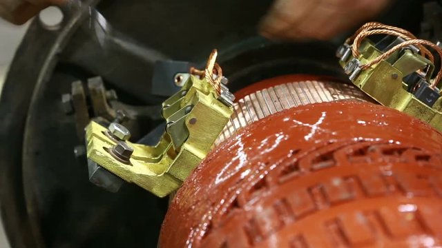 Mechanic repairing electric generator, repair of starter. motor mechanic repairs