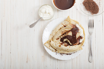 pancakes with chocolate on white table