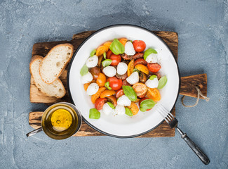 Italian Caprese salad with cherry tomatoes, small mozzarella and fresh basil