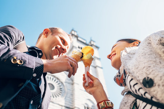 Couple in love with ice-cream cones on San Lorenco Cathedral bac