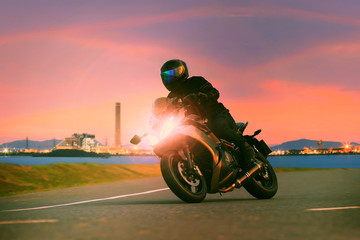 young man riding sport touring motorcycle on asphalt highways ag