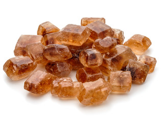 Brown caramelized lump cane sugar cube isolated on white backgro