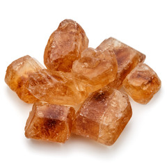 Brown caramelized lump cane sugar cube isolated on white backgro