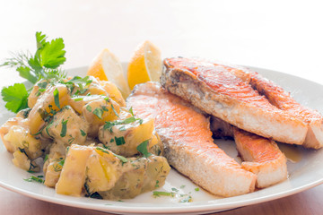 Grilled salmon, baked potatoes and vegetables