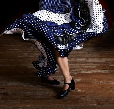 Legs of a woman flamenco dancing in traditional clothing