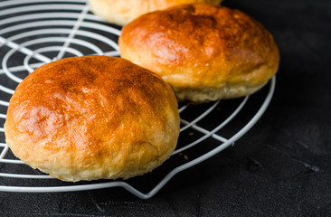 Homemade buns for burgers on dark slate background. Selective focus