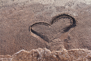 drawing a heart on the beach