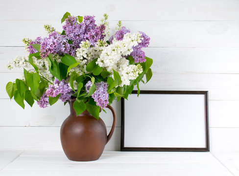 Lilac bouquet in jug with motivational frame