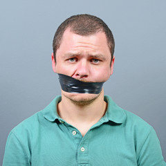Kidnapped man with tape over his mouth