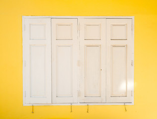 Obraz na płótnie Canvas white window on yellow wall