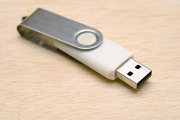 Blank USB thumb drive isolated on wooden board background