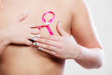 Naked woman with breast cancer awareness ribbon