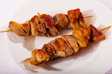Skewers on white plate
