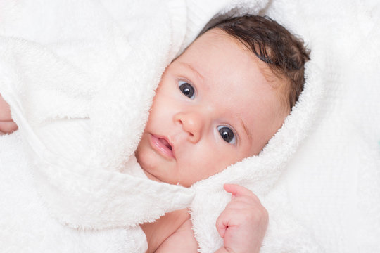 Cute baby in white towel portrait