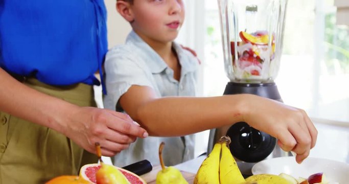 Mom and son preparing juice