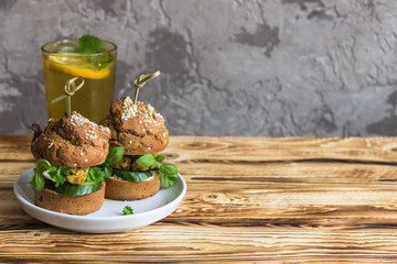 Healthy Burgers with chicken cutlet, basil and parsley, a roll of rye flour with sesame seeds. Copyspace.