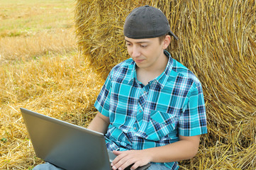 Naklejka na ściany i meble a business man in a countryside with a laptop
