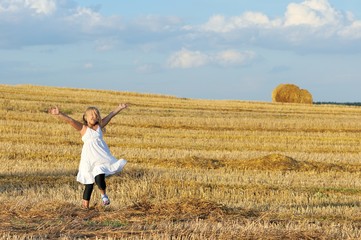 Naklejka na ściany i meble little girl outdoors in sunny summer day