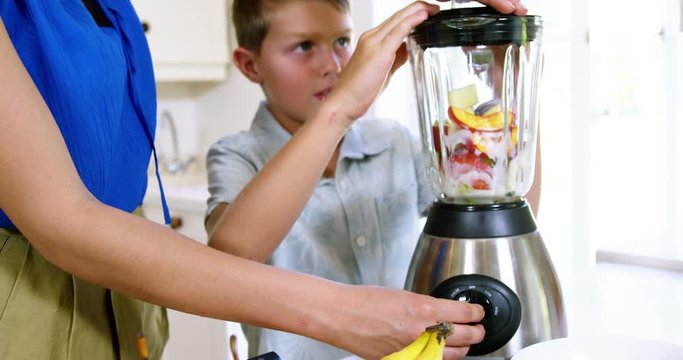 Mon and son preparing juice