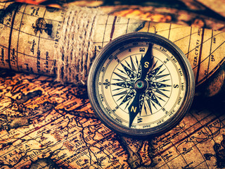 Old vintage compass on ancient map
