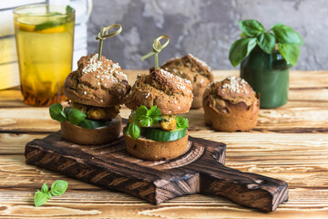 Healthy Burgers with chicken cutlet, basil and parsley, a roll of rye flour with sesame seeds. 