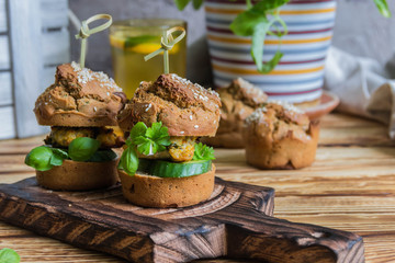 Healthy Burgers with chicken cutlet, basil and parsley, a roll of rye flour with sesame seeds. 