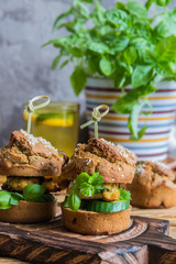 Healthy Burgers with chicken cutlet, basil and parsley, a roll of rye flour with sesame seeds. 